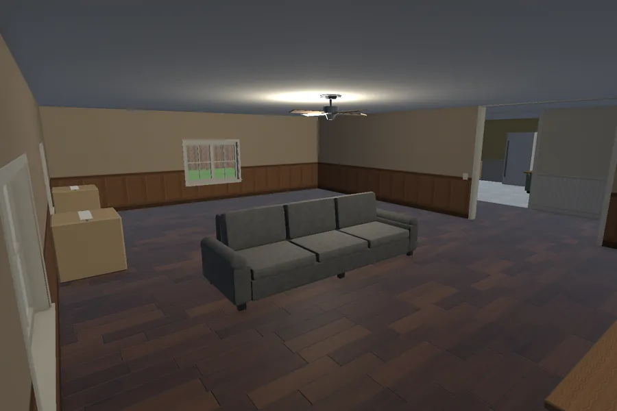 A living room with a grey three-seat couch, moving boxes and a ceiling fan